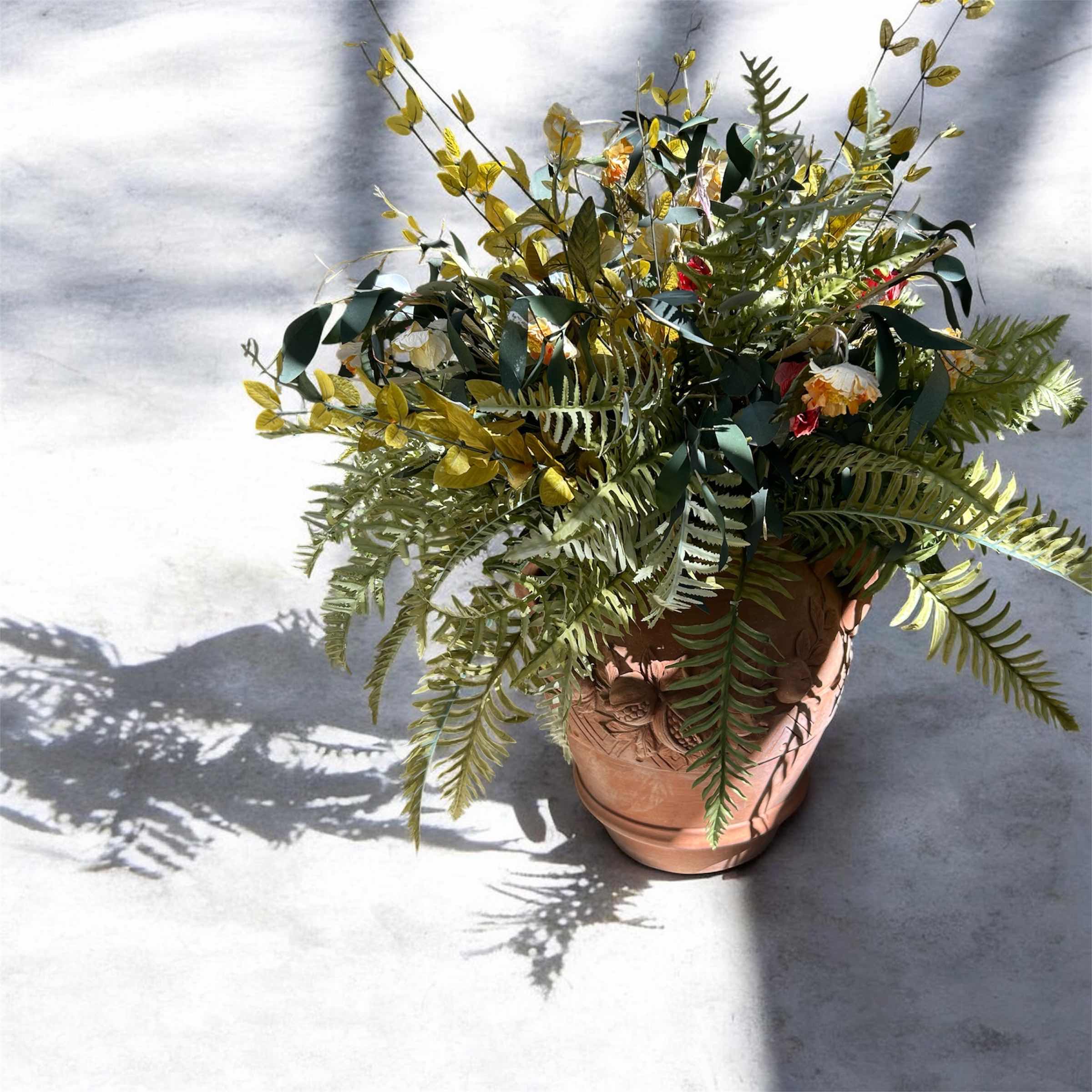 Photo 1 of ARTIFICIAL BOSTON FERN IN A CARVED TERRACOTTA URN H 43"