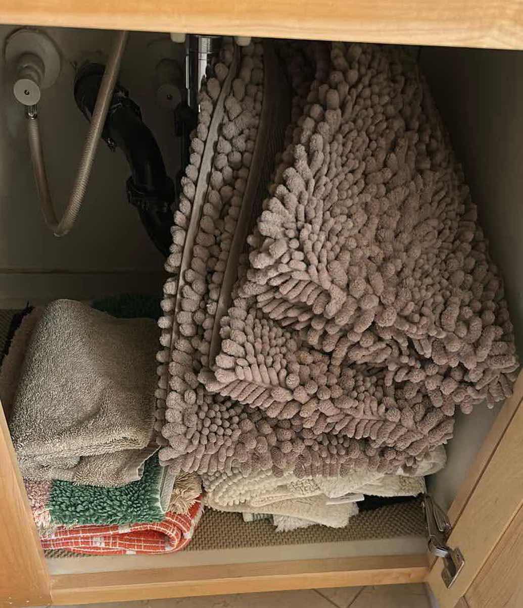 Photo 1 of CONTENTS OF CABINET TOWELS RUGS