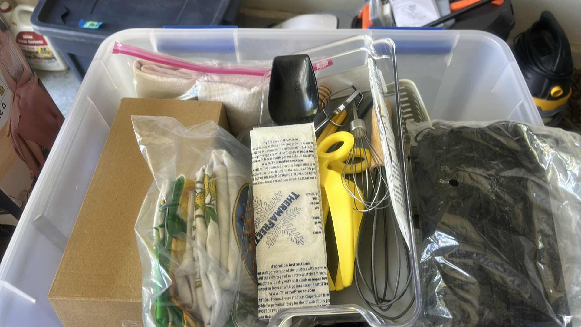 Photo 1 of ASSORTED CRAFT, SEWING, AND HOUSEHOLD SUPPLIES INCLUDING SCISSORS, THREAD, FABRIC, CORDS, CLIPS, AND SMALL TOOLS IN A PLASTIC STORAGE TOTE.
