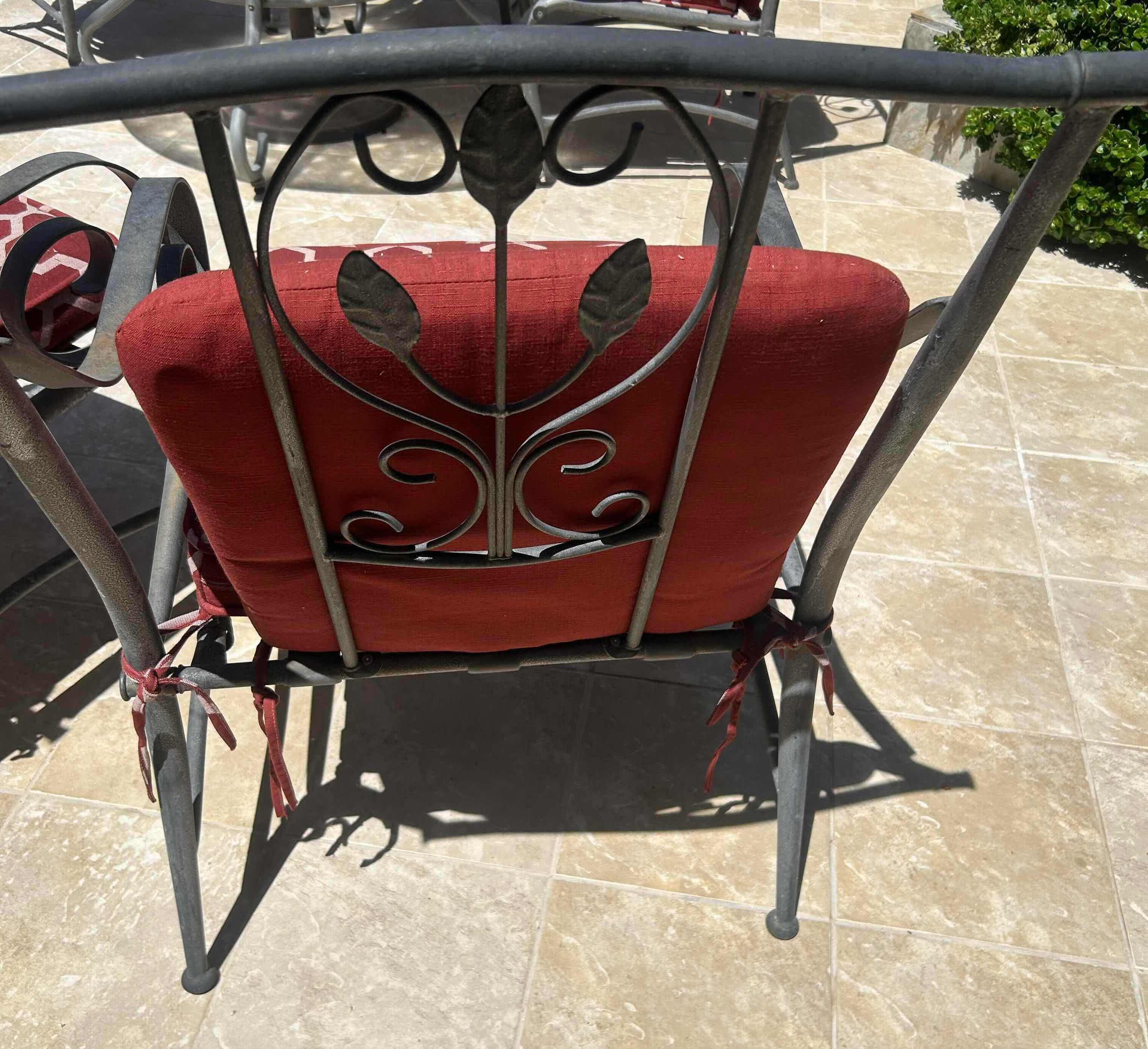 Photo 1 of RED GREY METAL OUT DOOR ARM CHAIR W GEOMETRIC TRELLIS PATTERN ON CUSHIONS