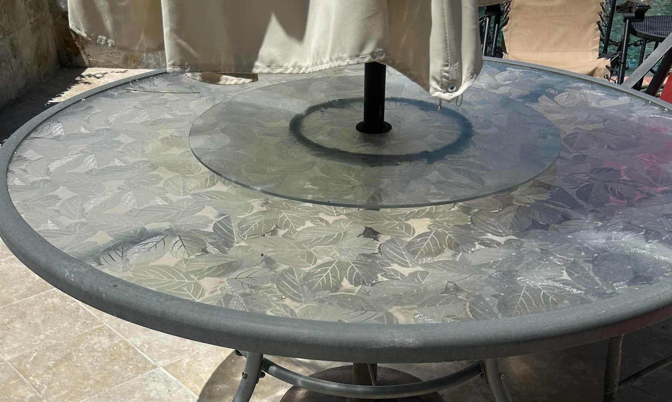 Photo 1 of GREY PATIO DINING TABLE W CIRCULAR GLASS TOP ETCHED W LEAF DESIGNS & INTEGRATED LASY SUSAN 60" CHAIRS SOLD SEPARATELY