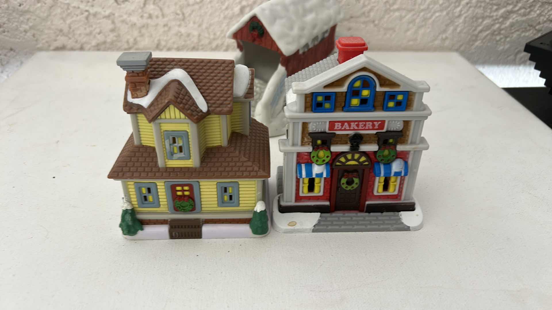 Photo 1 of FIVE MINIATURE PLASTIC CHRISTMAS VILLAGE PIECES AND ONE CERAMIC PIECE H4.5”