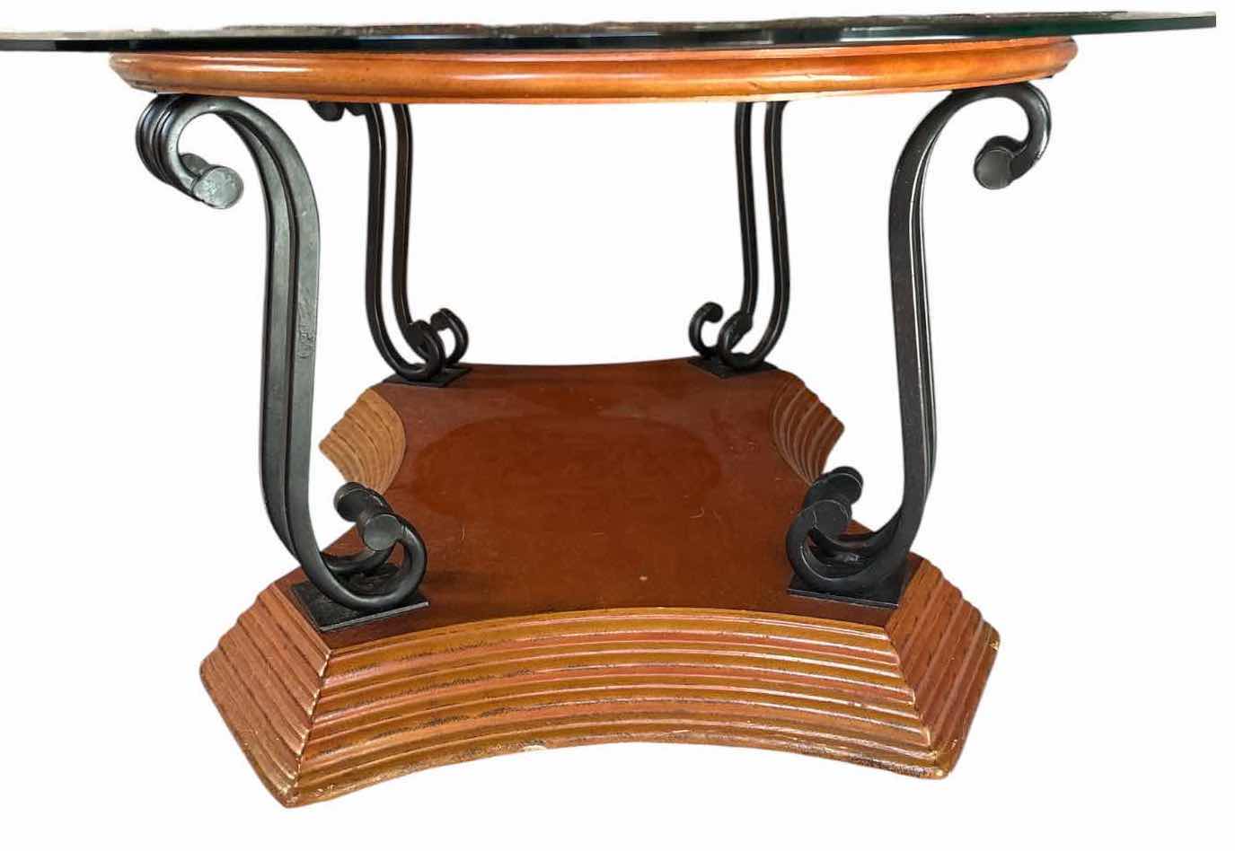 View 2 of OVAL GLASS TOP COFFEE TABLE WITH BROWN WOOD & BLACK METAL SCROLL BASE 51”X36”H18” $200