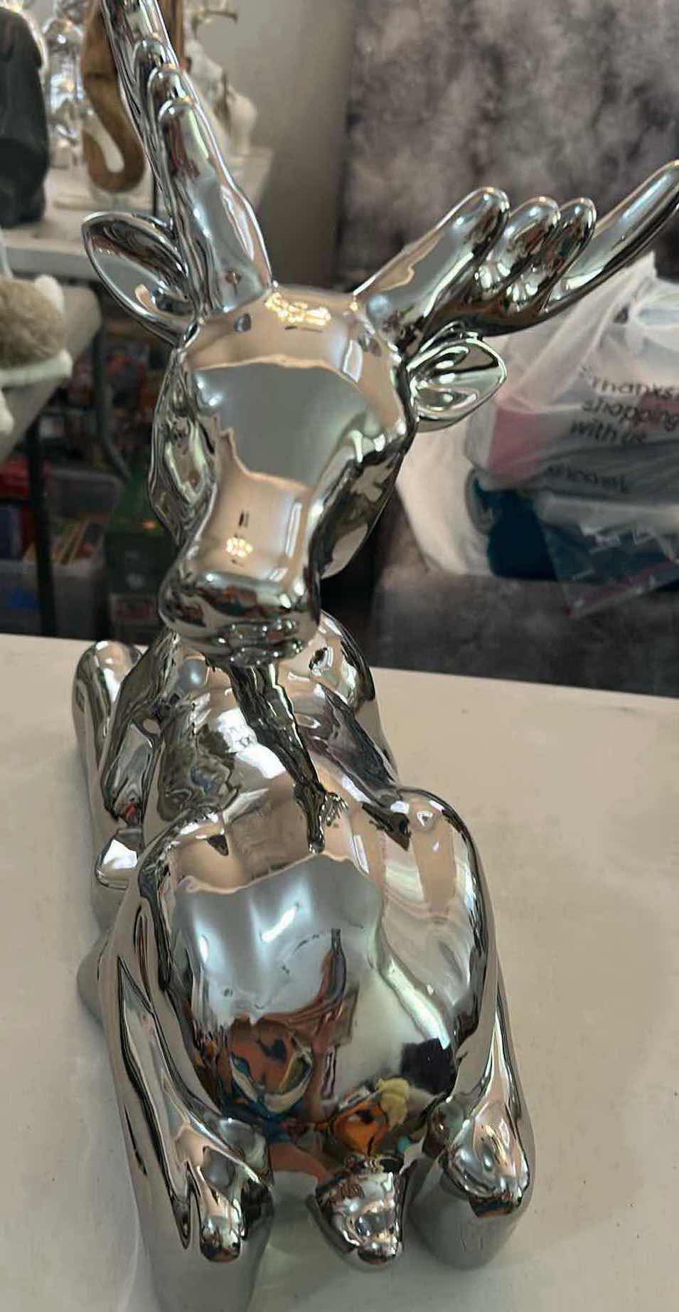 Photo 1 of PRECIOUS METAL SILVER TONED RESTING DEER W REFLECTIVE METALLIC CHROME FINISH CURVED ANTLERS 15" X 15"