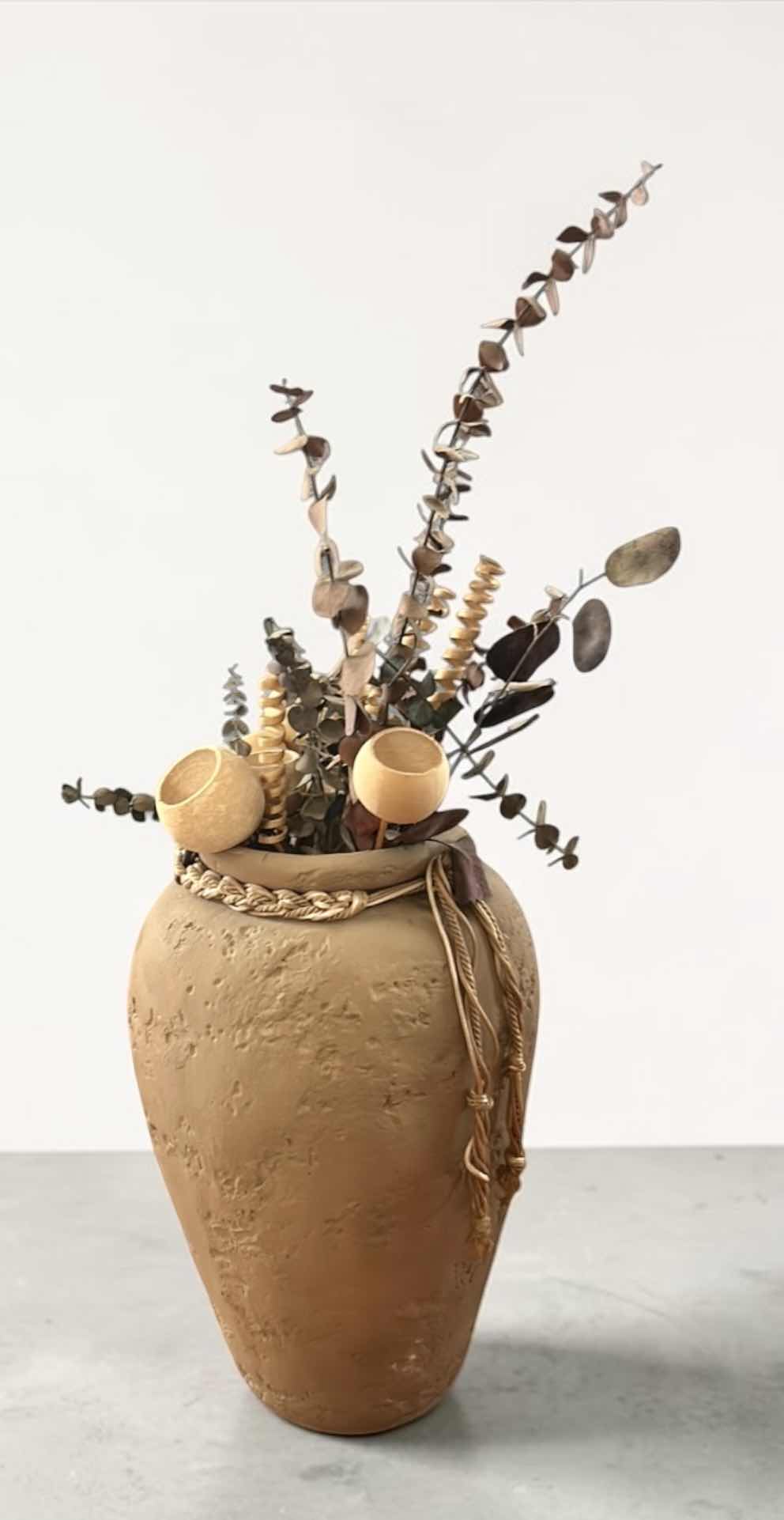 Photo 1 of TERRA-COTTA VASE FEATURING A RUSTIC URN SHAPE WITH A DECORATIVE BRAIDED ROPE, ACCENT AND FAUX FLOWERS H18”