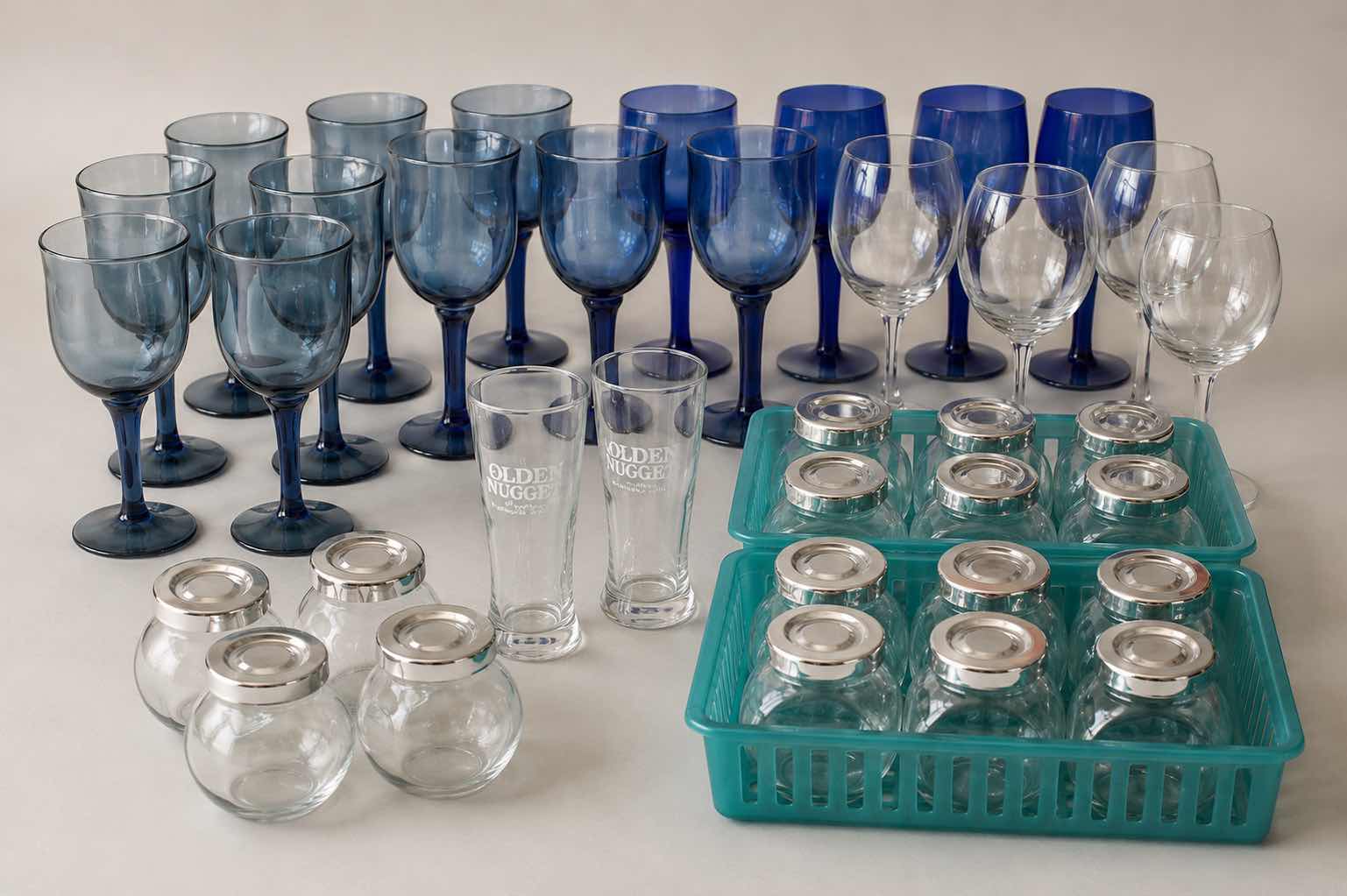 Photo 1 of COLLECTION FEATURING SEVERAL TYPES OF DRINKWARE, INCLUDING VINTAGE CRISTAR SKY BLUE RIOGA WINE, GLASSES AND STEMLESS, GOLDEN NUGGET BRANDED TUMBLERS ARE