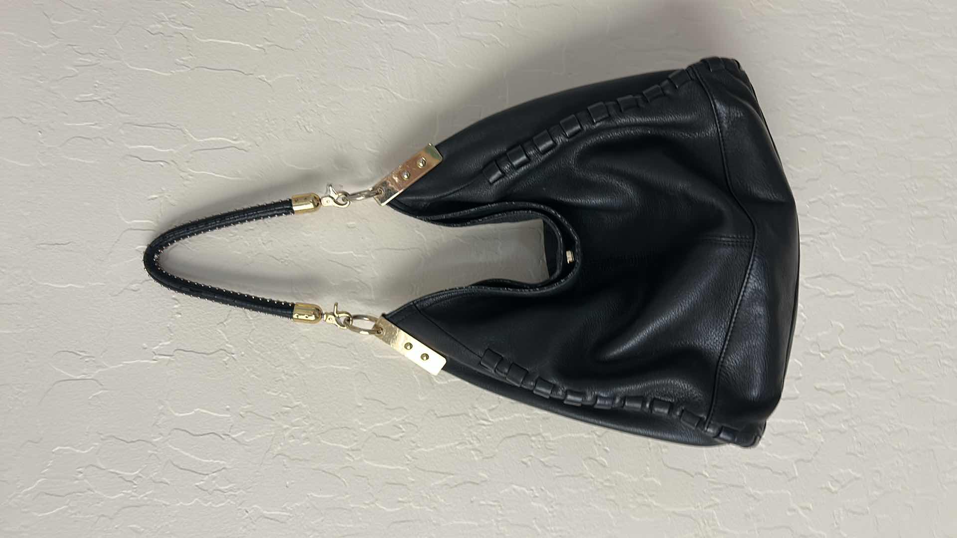 Photo 1 of VINCE CAMUTO, BLACK LEATHER, WHIPSTITCH HOBO BAG. $100