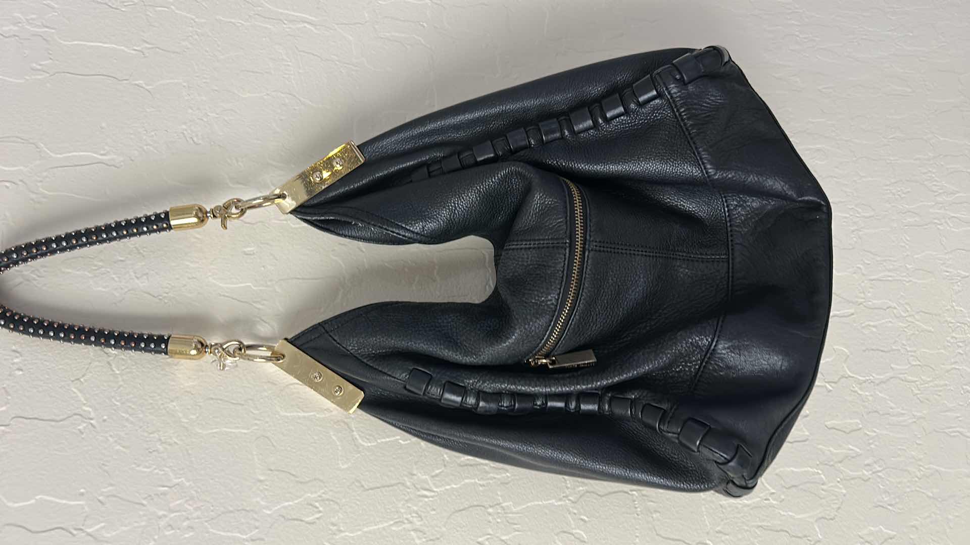 Photo 1 of VINCE CAMUTO, BLACK LEATHER, WHIPSTITCH HOBO BAG. $100