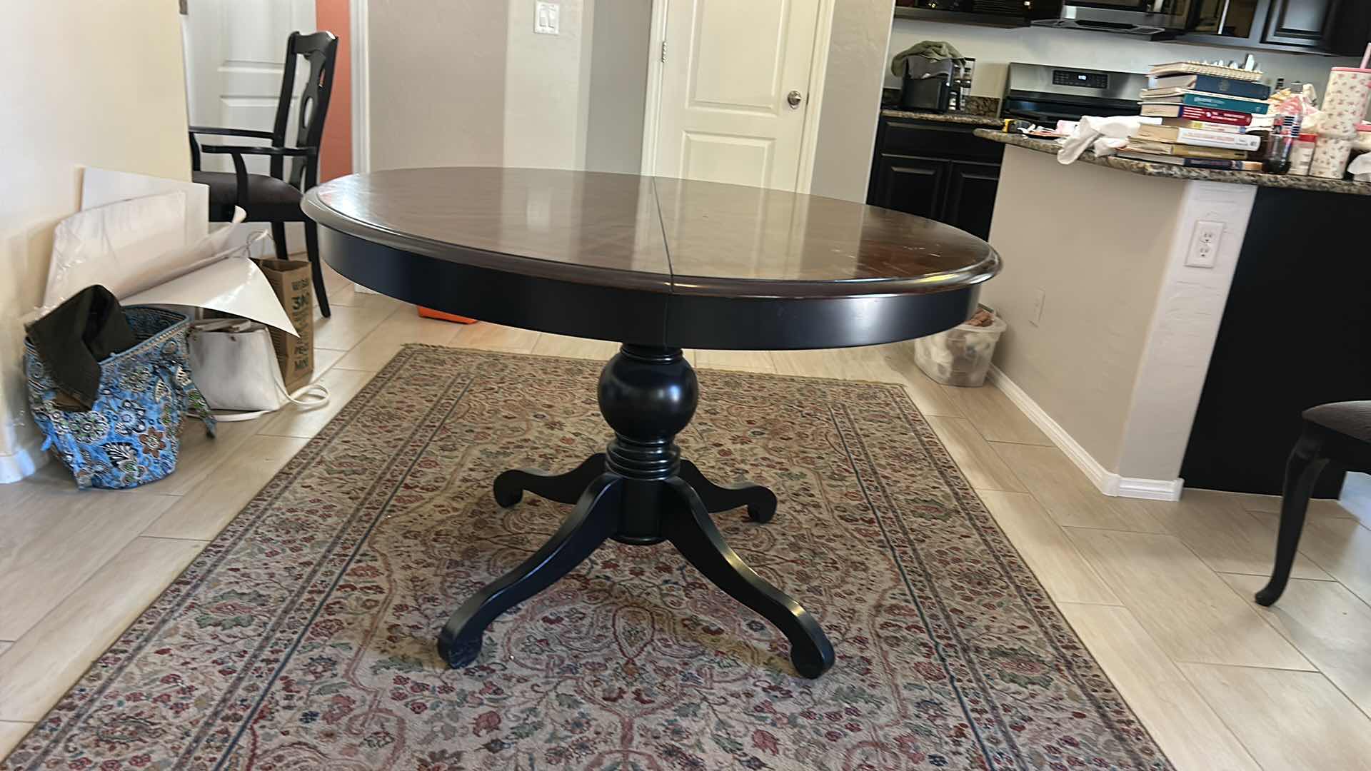 Photo 1 of MAHOGANY ROUND PEDESTAL DINING TABLE WITH DISTINCTIVE STARBURST VENEER PATTERN ON THE TOP AND A BLACK EBONIZED BASE. 4’ x 30” W/ 19” LEAF