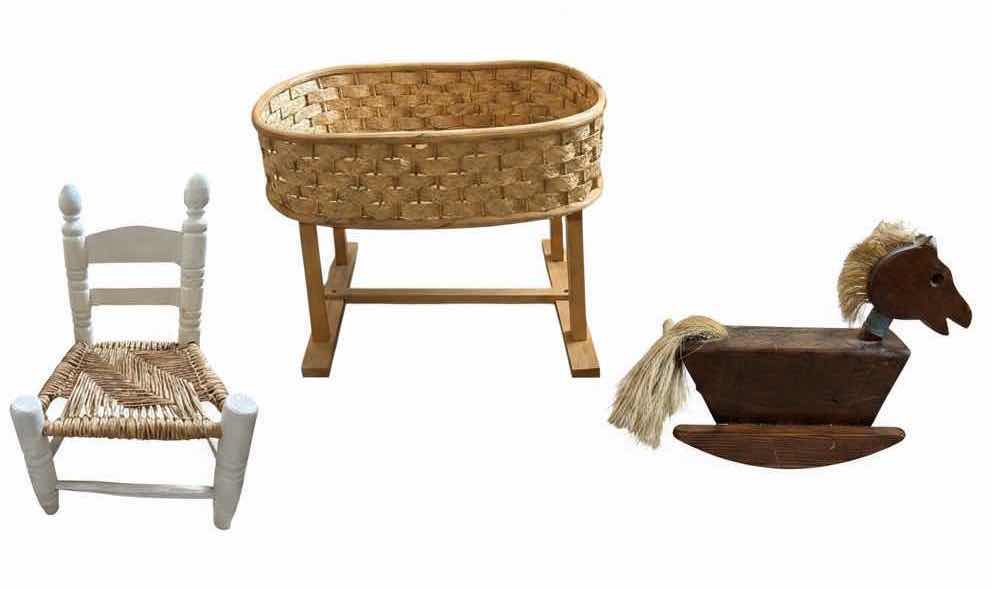 Photo 1 of WICKER DOLL CRADLE ON STAND, HANDCRAFTED WOODEN ROCKING HORSE, AND A WHITE RUSH SEAT CHILDS CHAIR 19”X13”H29” $160