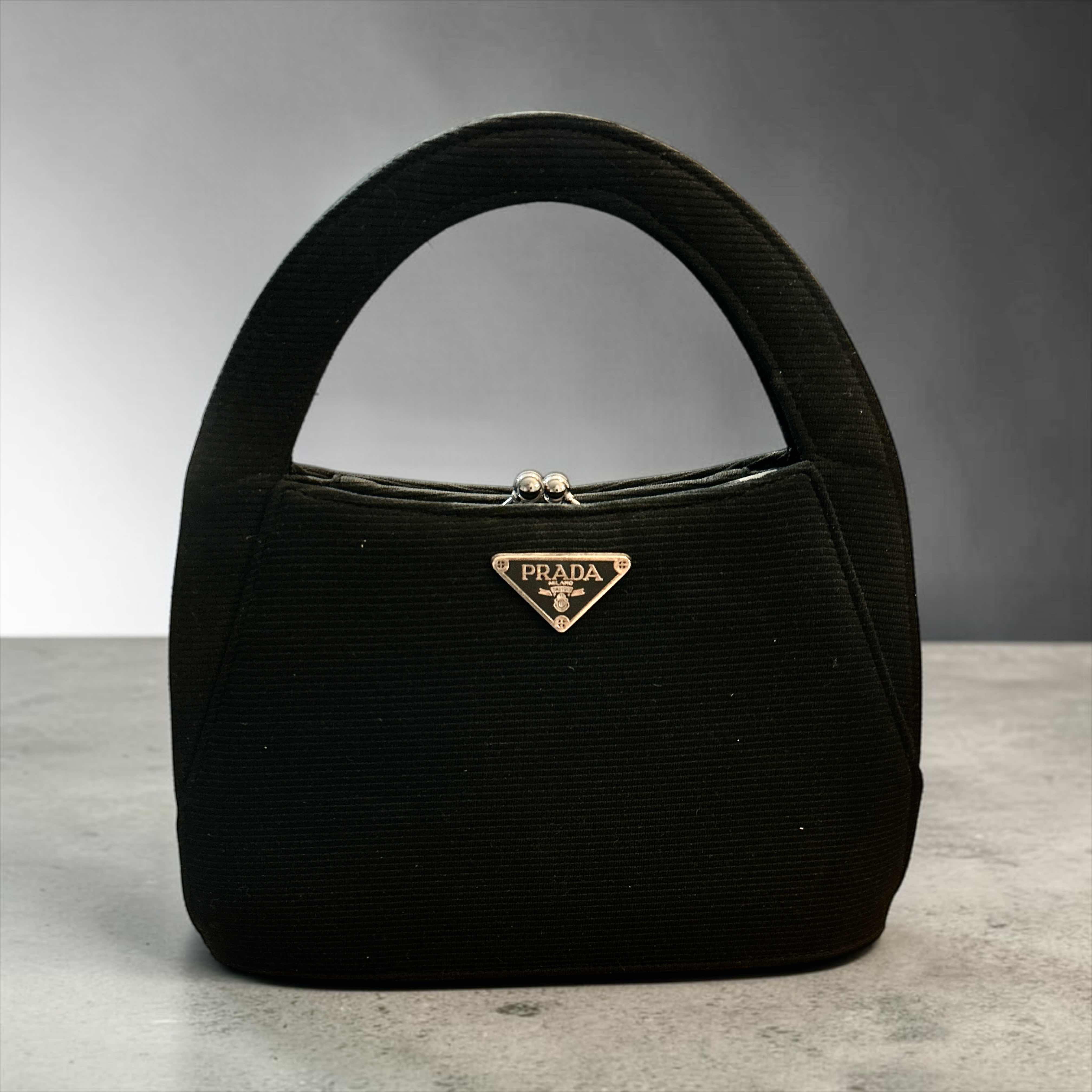 Photo 1 of IMITATION VINTAGE PRADA FEATURING A RIGID TOP HANDLE FRAME AND A KISS LOCK CLOSURE