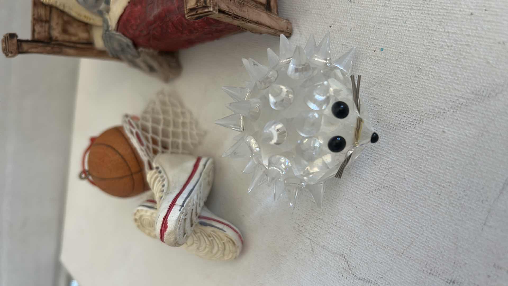 Photo 1 of FOUR BASKETBALL ORNAMENTS, GLASS, PORCUPINE & CERAMIC FIGURINE OF CAT IN BED H2.5”