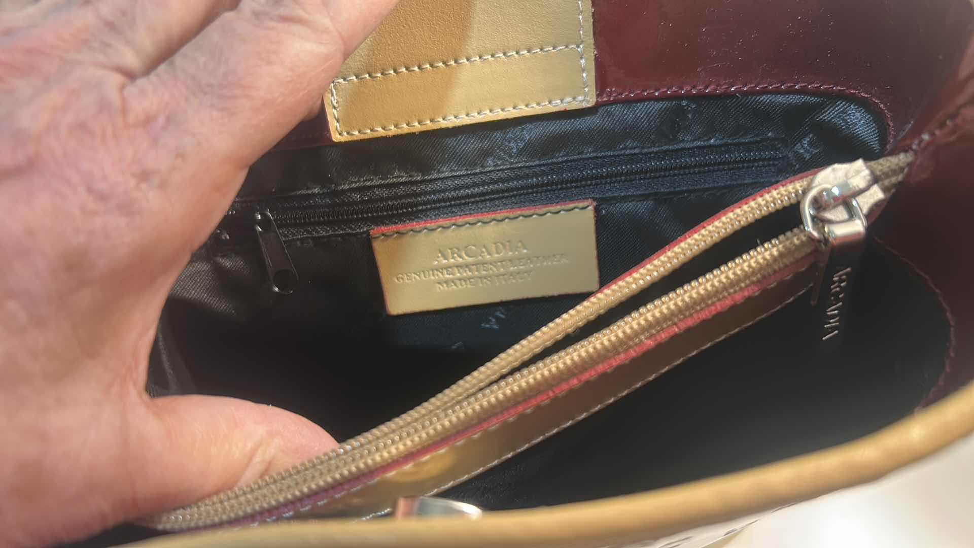 Photo 1 of ARCADIA BURGUNDY EMBOSSED MONOGRAM PATENT LEATHER BUCKET BAG