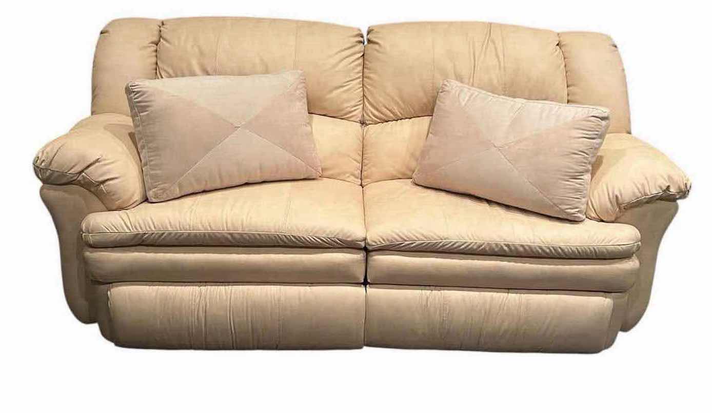 Photo 1 of OFF WHITE LEATHER RECLINING SOFA W COMFORTABLE PADDED CUSHIONS W DIAGONAL SEAM DETAIL 2 ACCENT PILLOWS