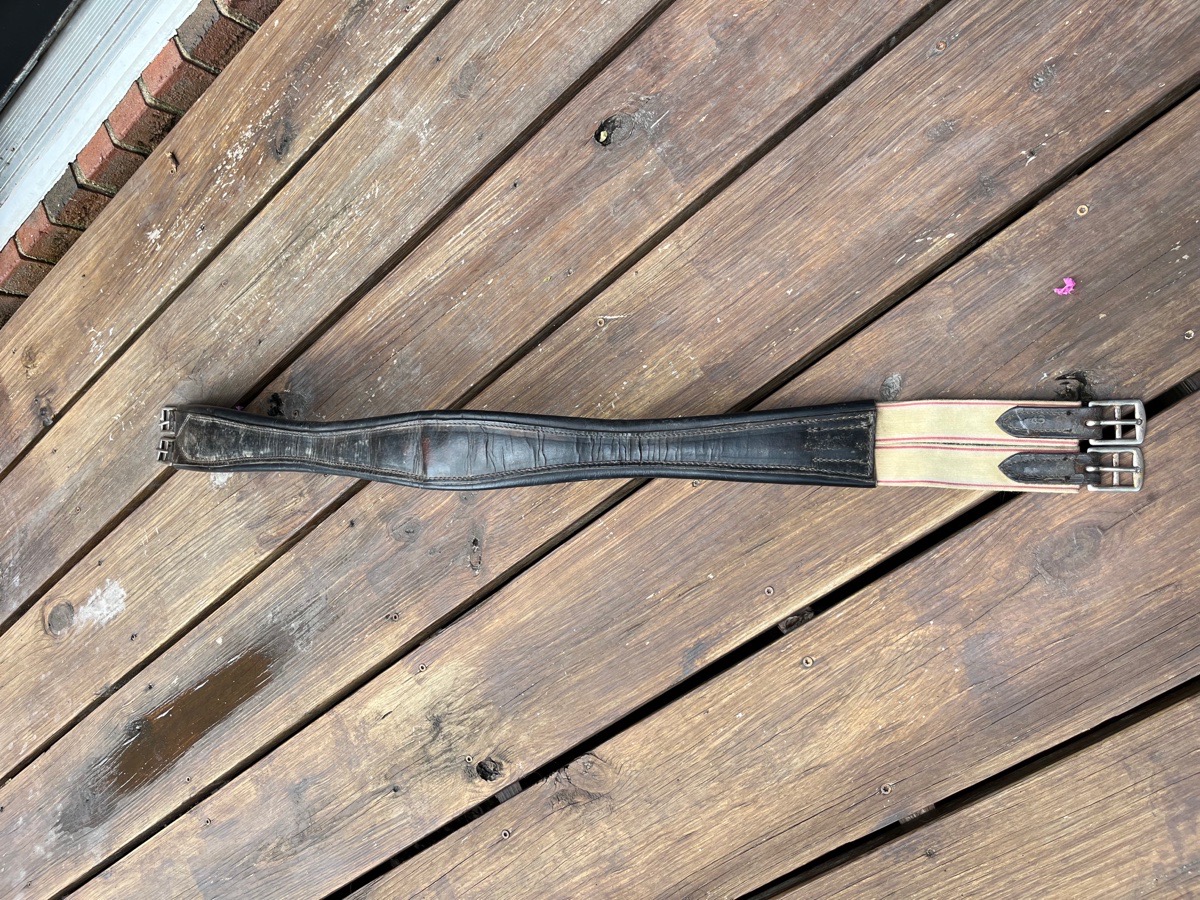 Leather girth with elastic end